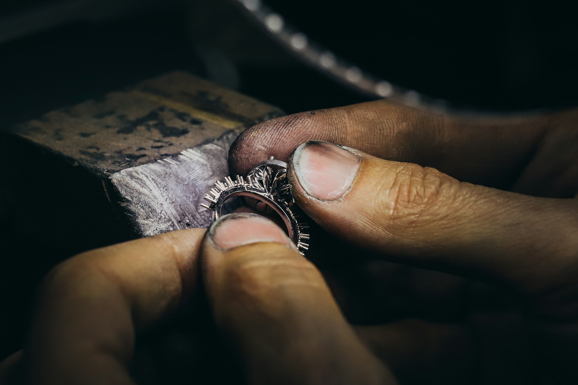 Hands finishing a custom gemstone ring