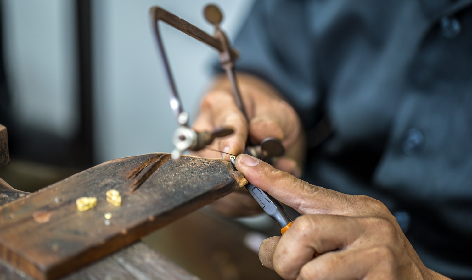 Jeweler crafting custom jewellery at the bench